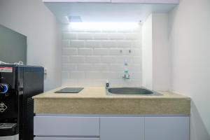 Comfort 1BR Apartment at Evenciio Margonda By Travelio