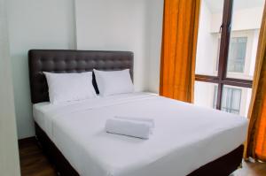 Spacious and Homey 2BR at Asatti Apartment By Travelio