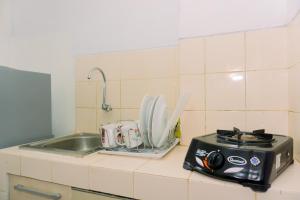 Nice and Homey 1BR at Serpong Greenview Apartment By Travelio