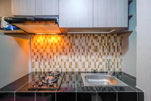 Cozy Living and Homey Studio Apartment at Margonda Residence 5 By Travelio