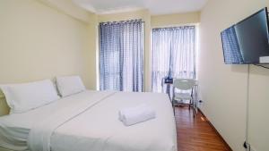 Homey and Cozy Living Studio Room at Tifolia Apartment By Travelio