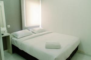 Cozy Studio Apartment at Aeropolis Residence No Kitchen near CGK Airport By Travelio