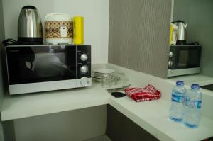 Cozy Studio Apartment at Aeropolis Residence No Kitchen near CGK Airport By Travelio