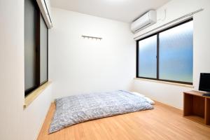 Dvoulůžkový pokoj Economy v japonském stylu s oddělenými postelemi a sdílenou koupelnou