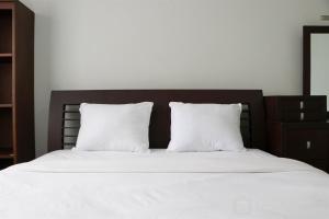 Cozy Living and Modern 2BR Puri Garden Apartment By Travelio