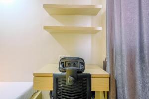 Cozy Living Studio Room at Evenciio Margonda Apartment By Travelio