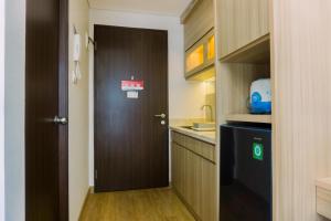 Minimalist and Warm Studio at Transpark Bintaro Apartment By Travelio