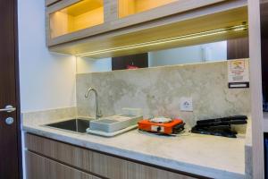 Minimalist and Warm Studio at Transpark Bintaro Apartment By Travelio