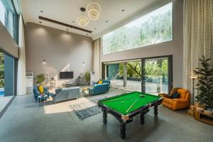 SaffronStays Six Degrees - 6BR pool villa with high-ceiling interiors, lawns, swings & pool table near Awas Beach