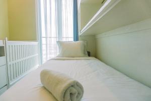 Spacious and Homey 2BR at Tree Park City Cikokol Apartment By Travelio