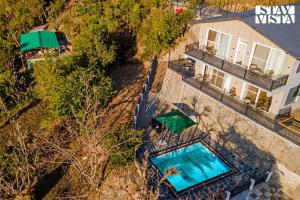 StayVista at Sunset Springs with Heated Swimming Pool