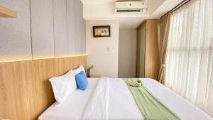 Homey and Good Place 2BR Transpark Bintaro Apartment By Travelio
