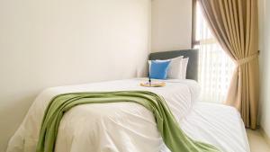 Homey and Good Place 2BR Transpark Bintaro Apartment By Travelio