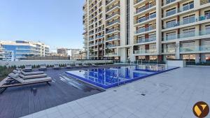 Vogue Vacation Homes, Arjan Jwelz by Danube near Miracle and Butterfly Garden, Studio Apartment with Balcony and Vibrant Community View, Access toAmenities