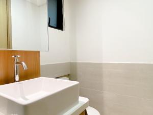 Spacious and Homey 2BR with Work Space at Meikarta Apartment By Travelio