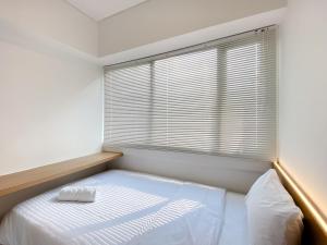 Spacious and Homey 2BR with Work Space at Meikarta Apartment By Travelio