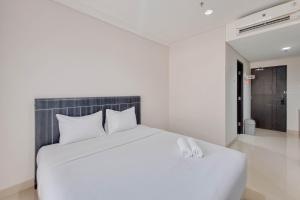 Homey and Scenic Studio at Patraland Amarta Apartment By Travelio