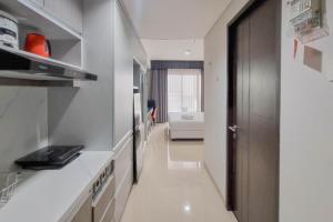 Homey and Scenic Studio at Patraland Amarta Apartment By Travelio