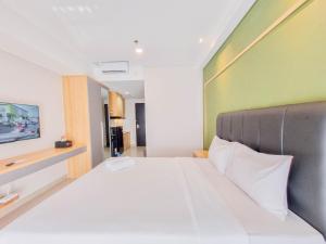 Homey and Minimalist Studio at Patraland Amarta Apartment By Travelio