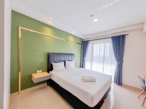 Homey and Minimalist Studio at Patraland Amarta Apartment By Travelio