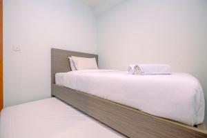 Combined 2BR with Study Room Titanium Square Apartment By Travelio