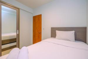 Combined 2BR with Study Room Titanium Square Apartment By Travelio