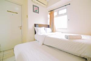 Best Price and Comfortable 2BR Green Pramuka City Apartment By Travelio