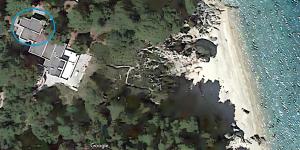 House in pines in front of the sea