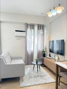 The Nialls Suites at HOPE Residences besides SM TRECE