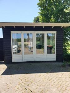 Light tiny house in green area with sauna option