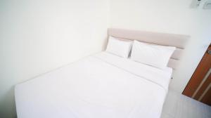 Cozy Living and Tidy 2BR at Puncak Dharmahusada Apartment By Travelio