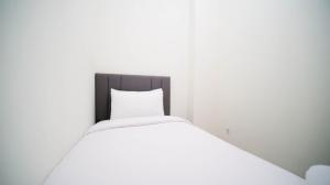 Cozy Living and Tidy 2BR at Puncak Dharmahusada Apartment By Travelio