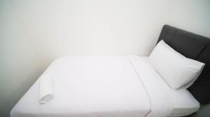 Cozy Living and Tidy 2BR at Puncak Dharmahusada Apartment By Travelio