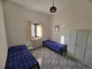 Camera Doppia con Letti Singoli e Bagno in Comune