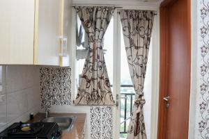 Comfy and Tidy Studio Apartment at Margonda Residence 4 near UI By Travelio