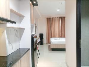 Elegant and Comfortable Studio Patraland Amarta Apartment By Travelio