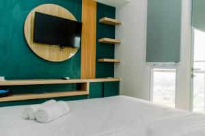 Nice and Simply Studio at Amazana Serpong Apartment By Travelio