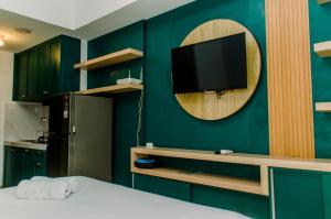 Nice and Simply Studio at Amazana Serpong Apartment By Travelio
