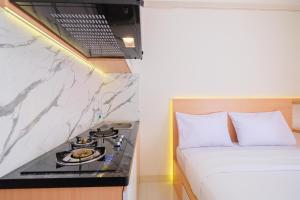 Nice and Comfy Studio at Green Pramuka City Apartment By Travelio