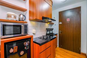Minimalist Studio Room at Transpark Cibubur Apartment near Shopping Center By Travelio