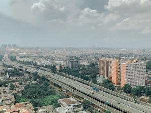 Minimalist Studio Room with City View at West Vista Apartment By Travelio