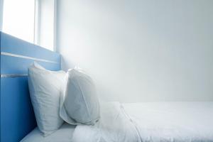 Homey and Fresh 2BR Green Pramuka Apartment By Travelio