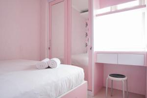 Homey and Fresh 2BR Green Pramuka Apartment By Travelio