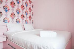 Homey and Fresh 2BR Green Pramuka Apartment By Travelio