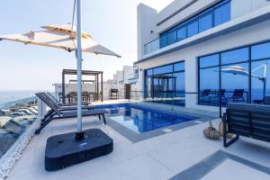 Overlooking Pool, Mountain and Sea 6BR Villa with Two Assistant Room, Heated Pool, BBQ Area, Al Dana Island, Fujairah by Deluxe Holiday Homes