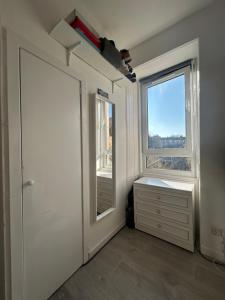 Bright bedroom with king side bed and share bathroom