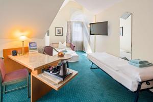 Comfort Quadruple Room with Queen Bed and Sofa Bed room in PLAZA Hotel Blankenburg Ditzingen Sure Hotel Collection