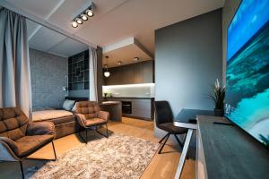 Modern central Riga apartment with balcony, gym access, dedicated parking, kitchen & AC