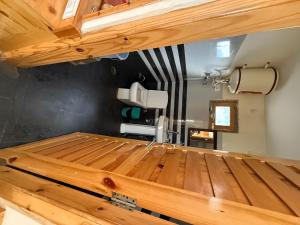 Luxury 1 BHK Apartment for Rent in Naggar,Manali with Modern Kitchen, Wooden Interior, and Spacious Bathroom