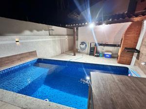 A Casa de Praia com ar, piscina aquecida e churrasqueira